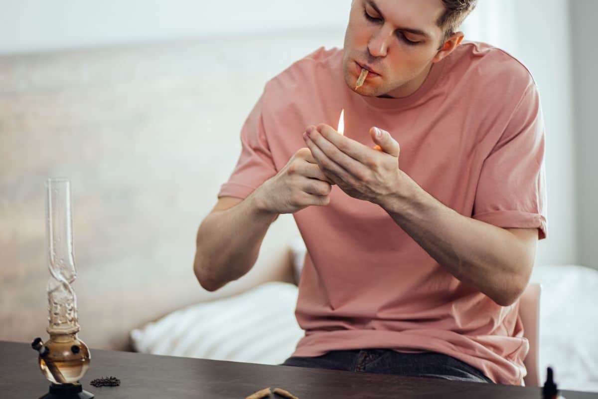 A guy smoking various weed products