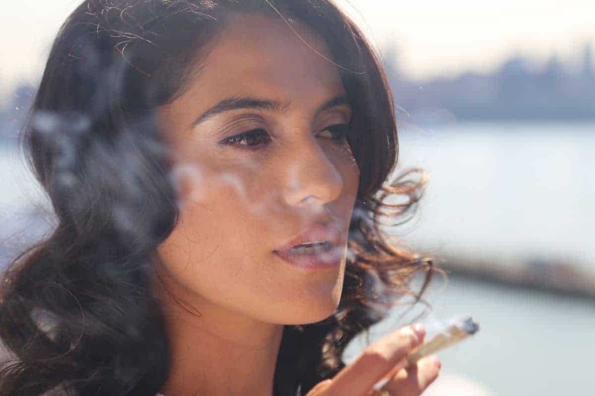 A lady smoking weed and having red eyes