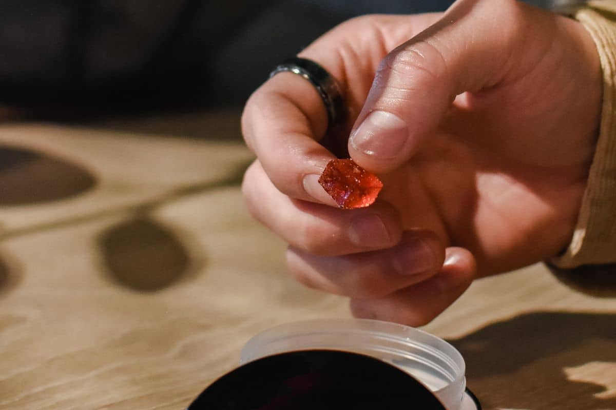 A woman holding Shruumz Gummies in her hand