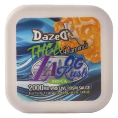 Dazed THCa Diamond Dabs 2g – LA OG Kush The image shows a blue and orange container of DazedA THCa Diamond Dabs LA OG Kush, featuring 2g with Live Rosin Sauce. This indica strain has 2000MG of product and under 0.3% THC, ideal for fans of THCa Diamond Dabs.