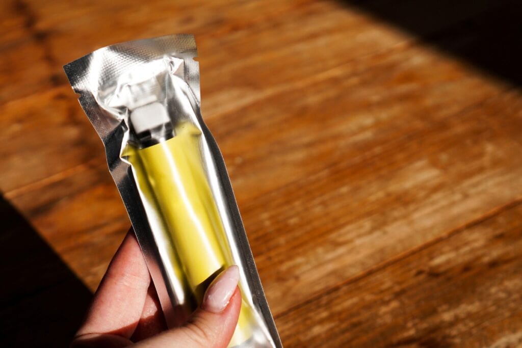 Woman holding vape in original packaging